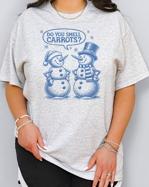 Woman wearing retro snowman shirt in ash grey color with the quote "Do You Smell Carrots?"