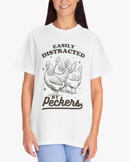 Woman wearing a 'Easily Distracted By Peckers' shirt in white, featuring a retro chicken graphic design and unisex fit.