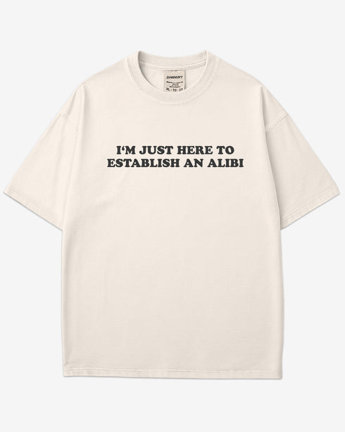 Flat lay ivory I'm Just Here To Establish An Alibi shirt.