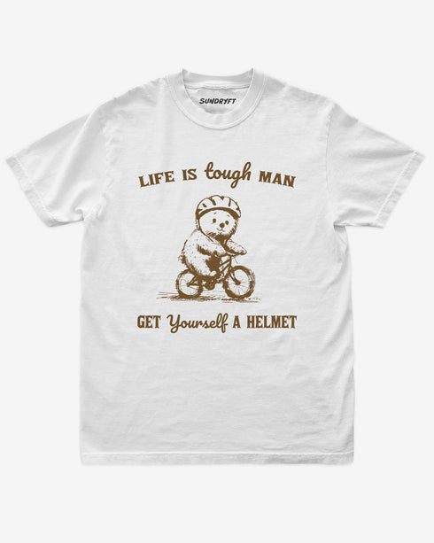 'Life Is Tough Man Get Yourself A Helmet' shirt in white with a retro graphic of a little bear riding a bycicle.