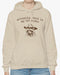 Woman wearing an 'Actually This is My First Rodeo' hoodie in sand beige, featuring a retro western graphic design and unisex fit.