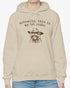 Woman wearing an 'Actually This is My First Rodeo' hoodie in sand beige, featuring a retro western graphic design and unisex fit.