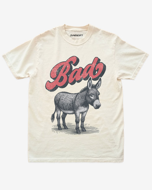 Ivory “Badass Donkey” funny pun retro graphic shirt flat lay.