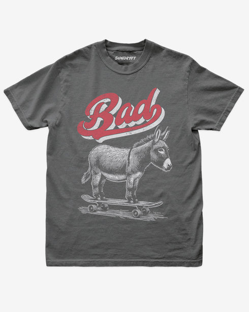 Pepper “Badass Donkey On Skateboard” funny retro skate pun shirt flat lay.