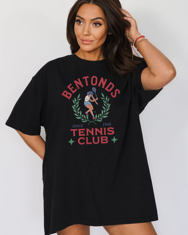Woman wearing "Bentonds Tennis Club" shirt in black color with a retro tennis player graphic.
