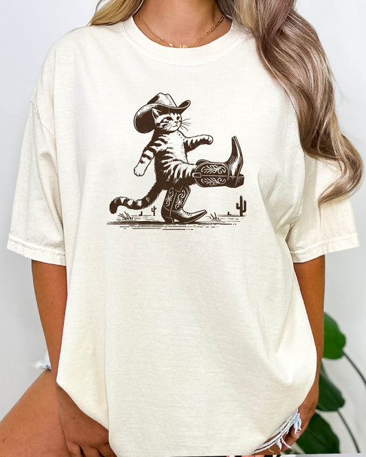 Woman wearing retro graphic cowboy cat shirt in natural beige color