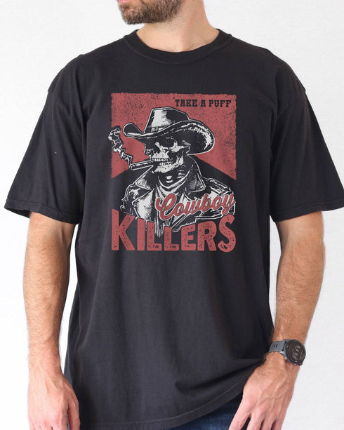Model wearing black color shirt with 'Cowboy Killers' funny smoking skeleton graphic design