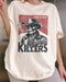 Close-up of model wearing ivory color shirt with 'Cowboy Killers' funny smoking skeleton graphic design