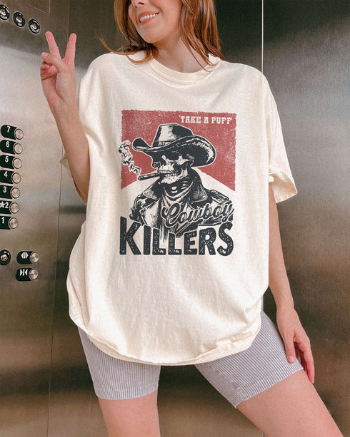 Model wearing ivory color shirt with 'Cowboy Killers' funny smoking skeleton graphic design