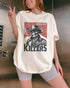 Model wearing ivory color shirt with 'Cowboy Killers' funny smoking skeleton graphic design