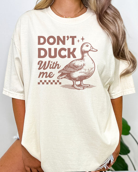 Woman wearing Don't Duck With Me shirt in natural beige color