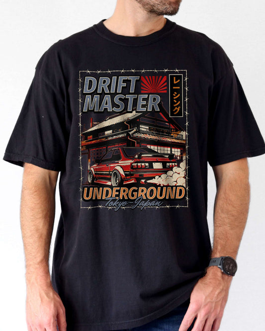 Man wearing a black Drift Master Tokyo shirt with a retro graphic of a race car and Japanese house.