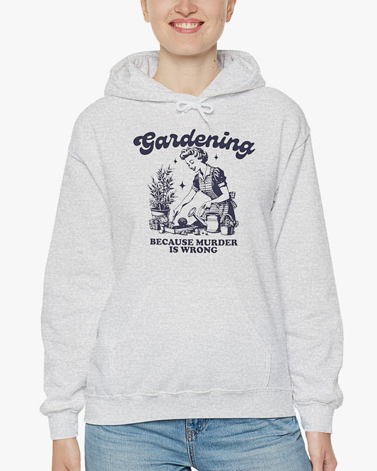 Woman wearing ash gray 'Gardening Because Murder Is Wrong' hoodie