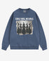 Flat lay denim 'Girls Will Be Girls' sweatshirt with retro graphic of witches holding hands in a Halloween ritual.