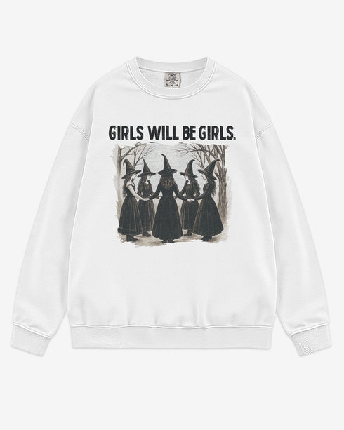 Flat lay white 'Girls Will Be Girls' sweatshirt with retro graphic of witches holding hands in a Halloween ritual.