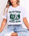 Model wearing ash color shirt with 'Go Outside Read A Book' graphic design