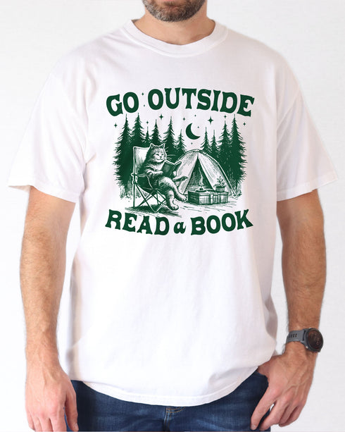Model wearing white color shirt with 'Go Outside Read A Book' graphic design