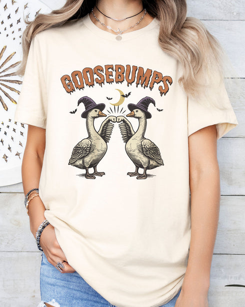 Model wearing natural color shirt with 'Goosebumps' funny Halloween graphic design