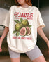 Woman wearing an ivory "Guavas – Tropical Sweetness" shirt with a retro graphic of guava fruits.