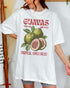 Woman wearing a white "Guavas – Tropical Sweetness" shirt with a retro graphic of guava fruits.