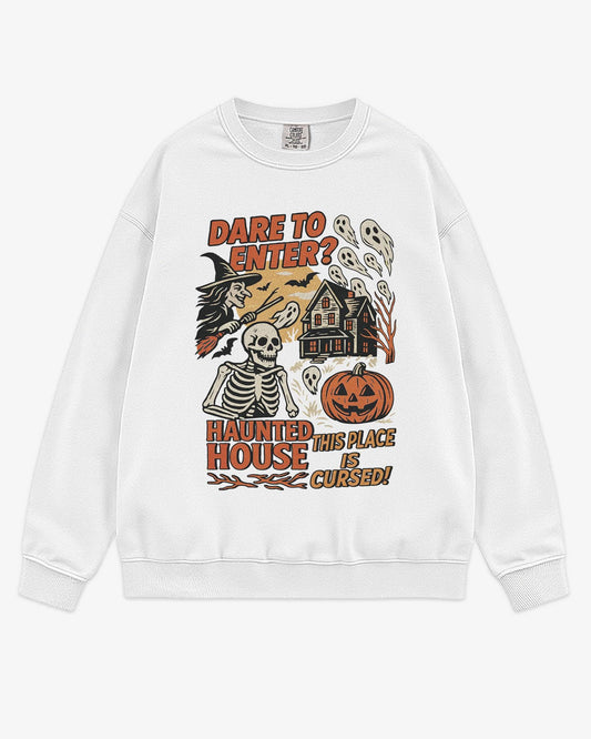 Flat lay white Halloween sweatshirt reading ‘Dare To Enter – Haunted House’ with retro graphic of haunted house, skeletons, and a witch.