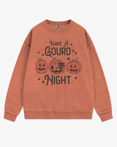 Flat lay terracotta ‘Have A Gourd Night’ sweatshirt with retro pumpkins and black cat graphic.