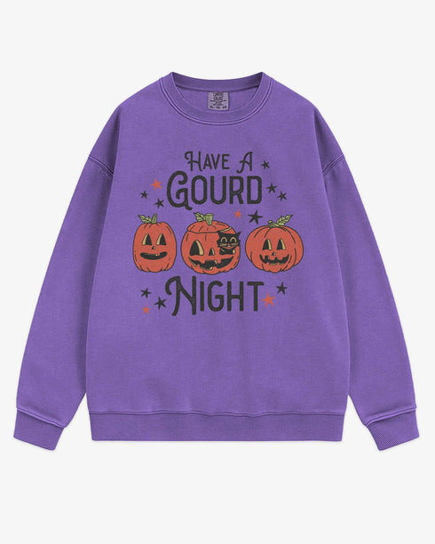 Flat lay violet ‘Have A Gourd Night’ sweatshirt with retro pumpkins and black cat graphic.
