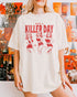 Woman wearing an ivory “Have A Killer Day” shirt with a funny Halloween graphic of bikini girls in hockey masks.
