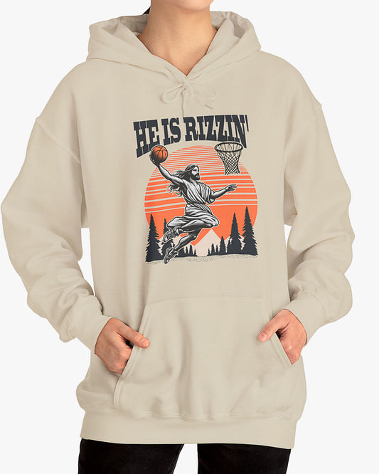 Woman wearing sand beige 'He Is Rizzin' hoodie featuring retro Jesus dunking basketball graphic, ideal for Easter.