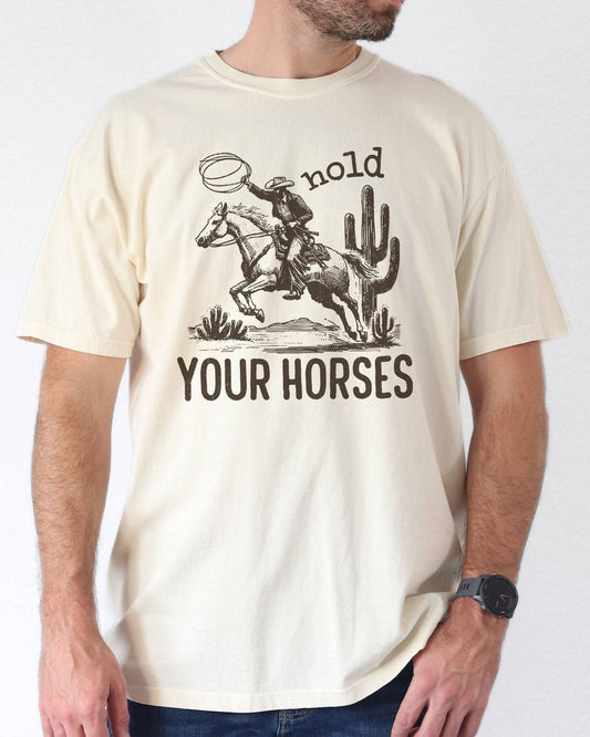 Man wearing ivory color shirt with 'Hold Your Horses' graphic design