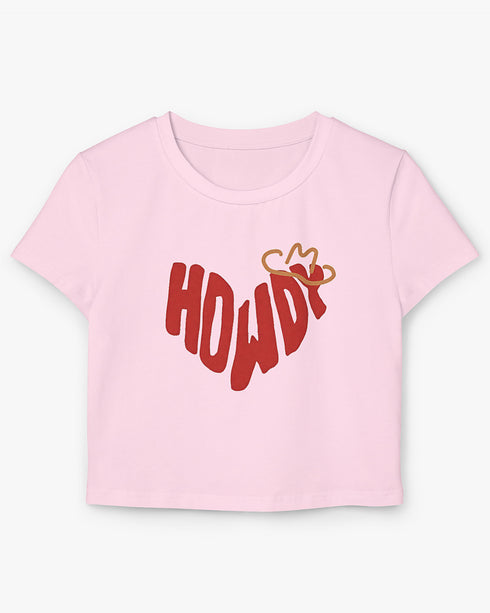 Howdy graphic women's baby tee in light pink lying flat