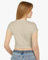 Back view of woman wearing a sand beige baby tee