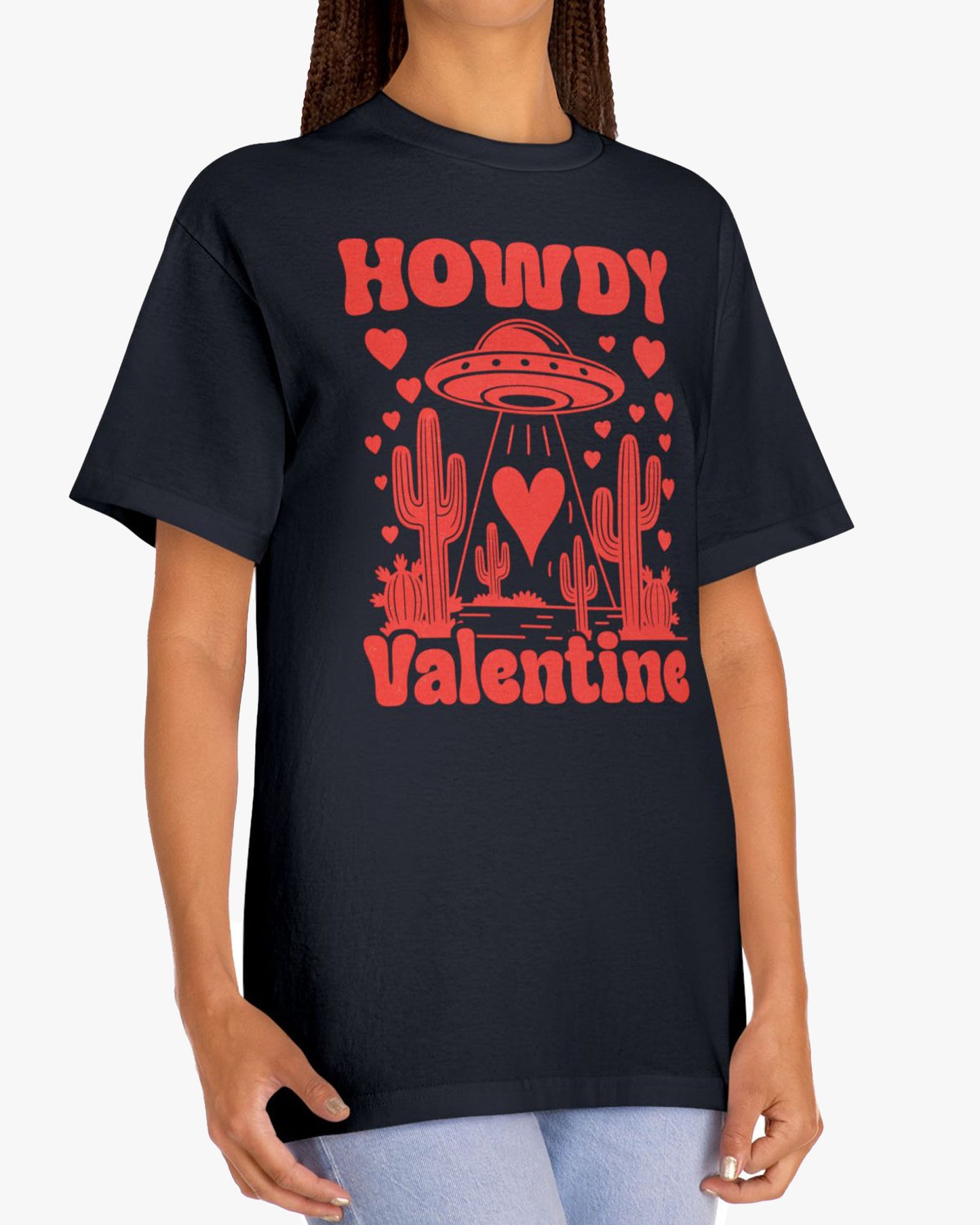 Woman wearing a black 'Howdy Valentine' shirt featuring a funny retro western landscape graphic with a UFO