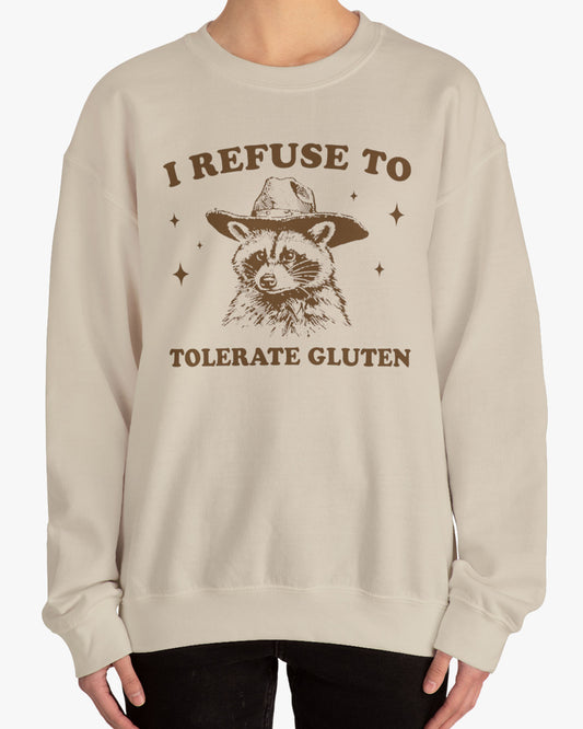 Woman wearing an 'I Refuse To Tolerate Gluten' sweatshirt in sand beige, featuring a retro cowboy raccoon graphic design and unisex fit.