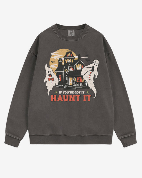 Flat lay pepper sweatshirt with phrase ‘If You’ve Got It Haunt It’ and retro graphic of two ghosts and a haunted house.