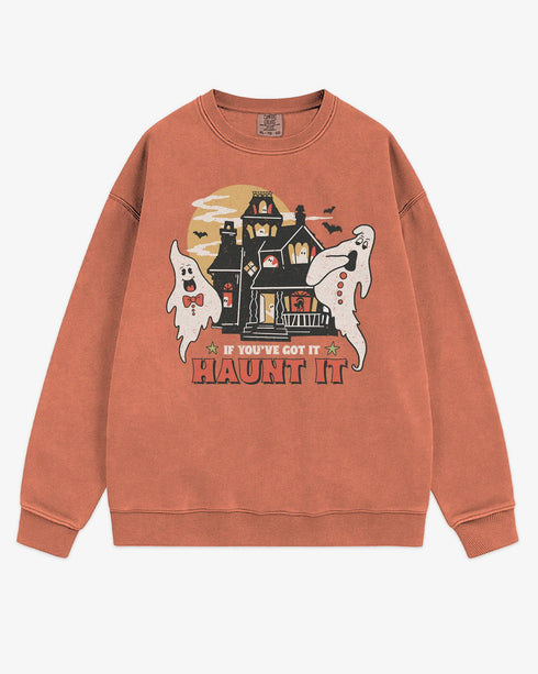 Flat lay terracotta sweatshirt with phrase ‘If You’ve Got It Haunt It’ and retro graphic of two ghosts and a haunted house.