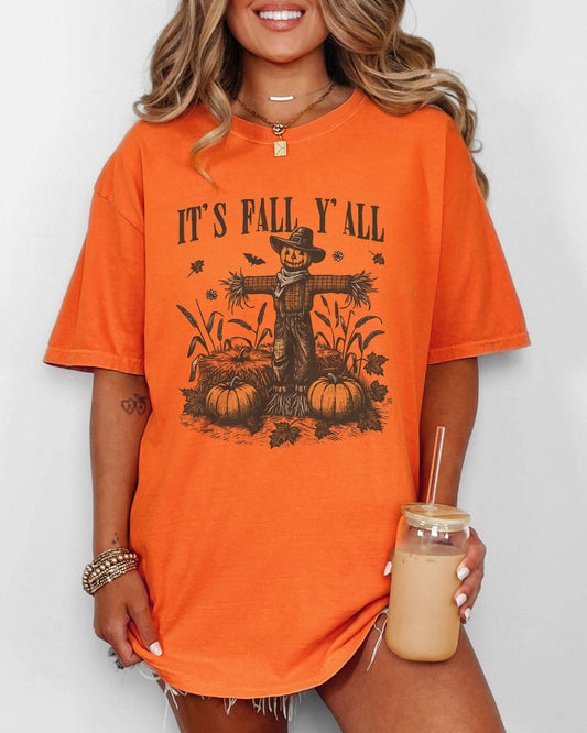 Model wearing burnt orange color shirt with 'It's Fall Y'all' graphic design