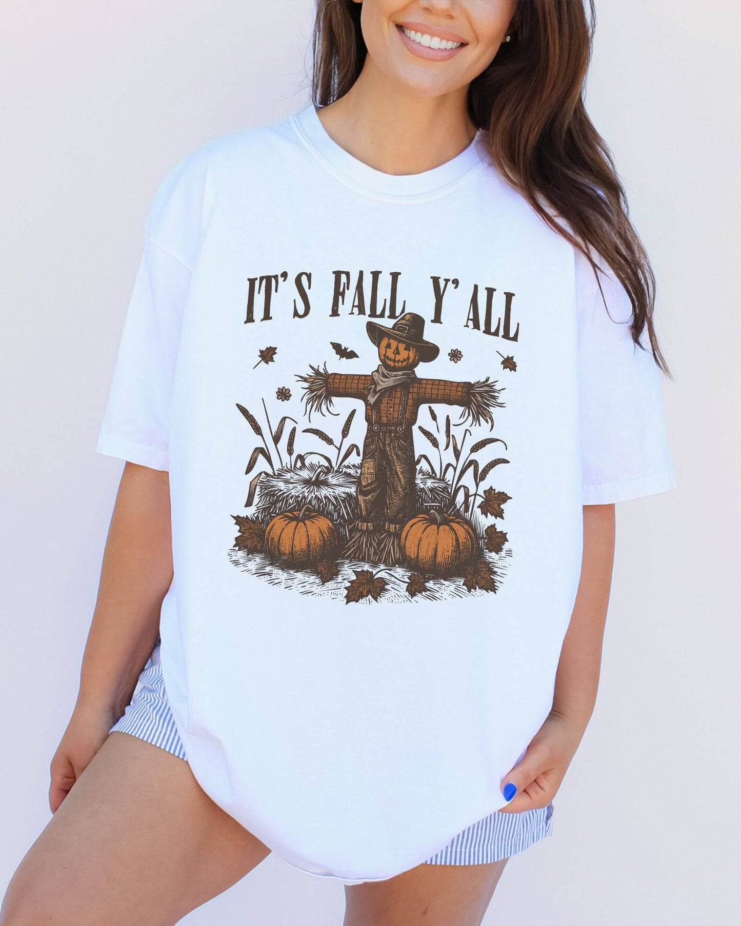 Model wearing white color shirt with 'It's Fall Y'all' graphic design