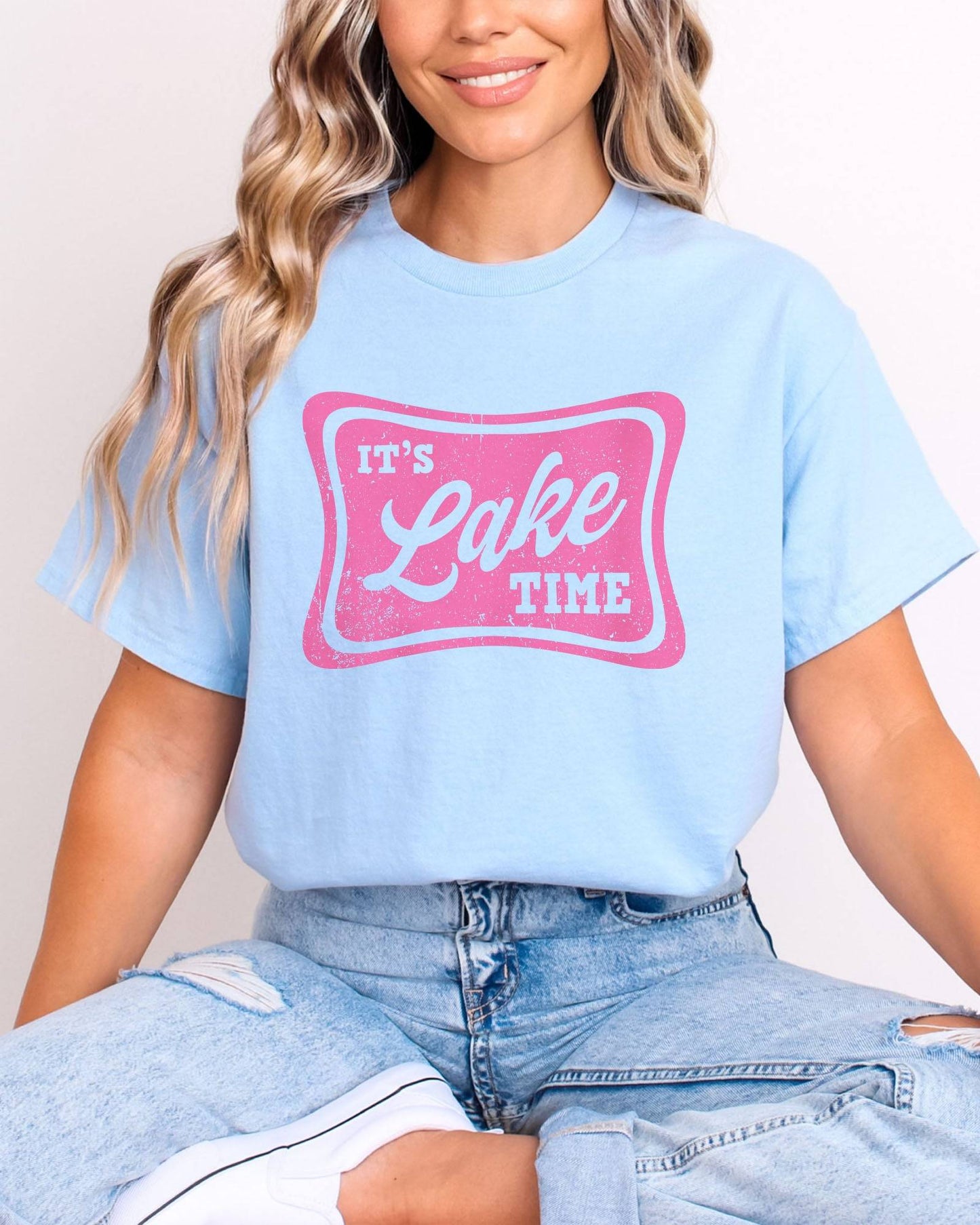 Model wearing light blue color shirt with 'It's Lake Time' graphic design