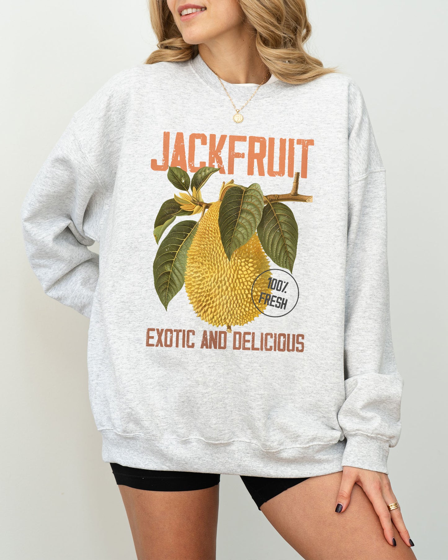 Model wearing ash color sweatshirt with jackfruit retro graphic design