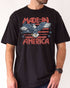 Man wearing "Made In America 1776" shirt in black color with retro graphic of a hawk in USA red-white-and-blue colors.