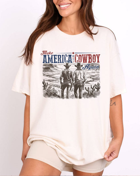 Model wearing natural color shirt with 'Make America Cowboy Again' graphic design