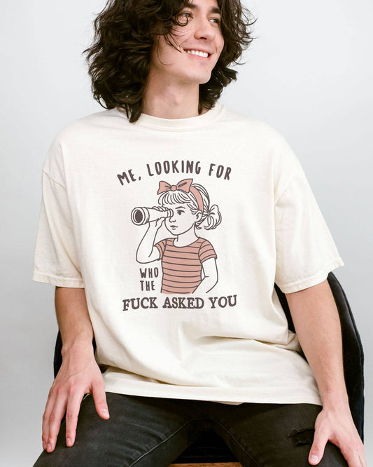 Man wearing ivory color shirt with 'Me, Looking For Who The Fuck Asked You' graphic design