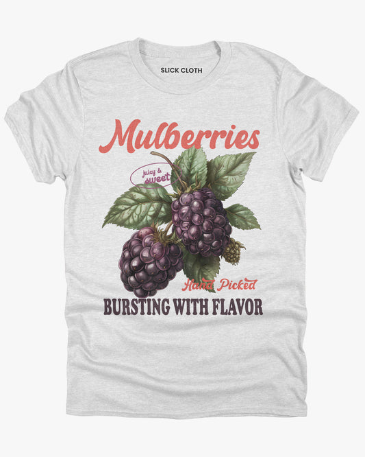 Flat lay of a ash gray t-shirt featuring a retro fruit graphic with the quote 'Mulberries - Bursting With Flavor.'
