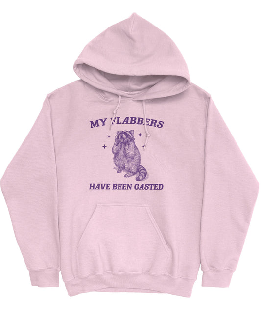 Flat lay of a light pink 'My Flabbers Have Been Gasted' hoodie featuring a funny retro raccoon freaking out graphic.