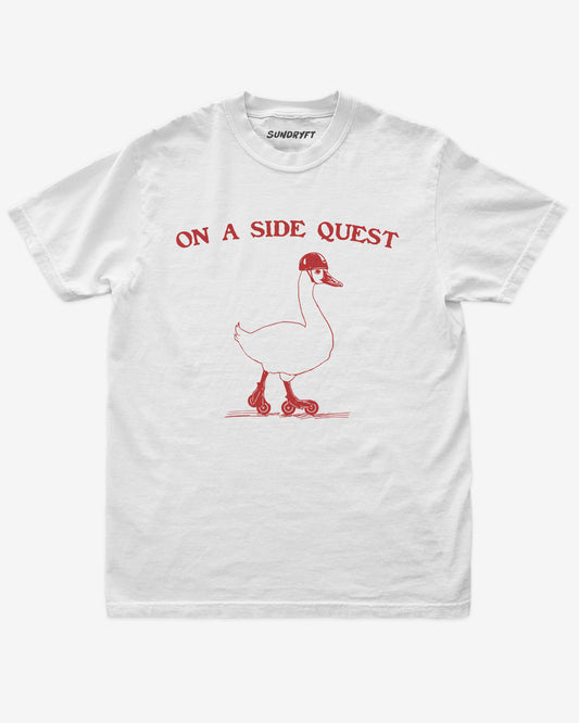 Flat lay of white On A Side Quest Shirt, retro 90s vintage graphic tee with funny roller-skating goose design