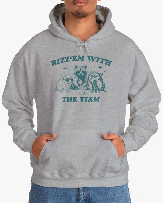 Man wearing a 'Rizz Em With The Tism' hoodie in sport gray, featuring a retro western graphic design and unisex fit.