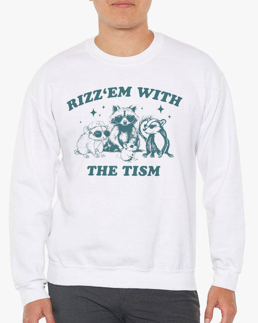 Man wearing a 'Rizz Em With The Tism' sweatshirt in white, featuring a retro raccoon gang graphic design and unisex fit.