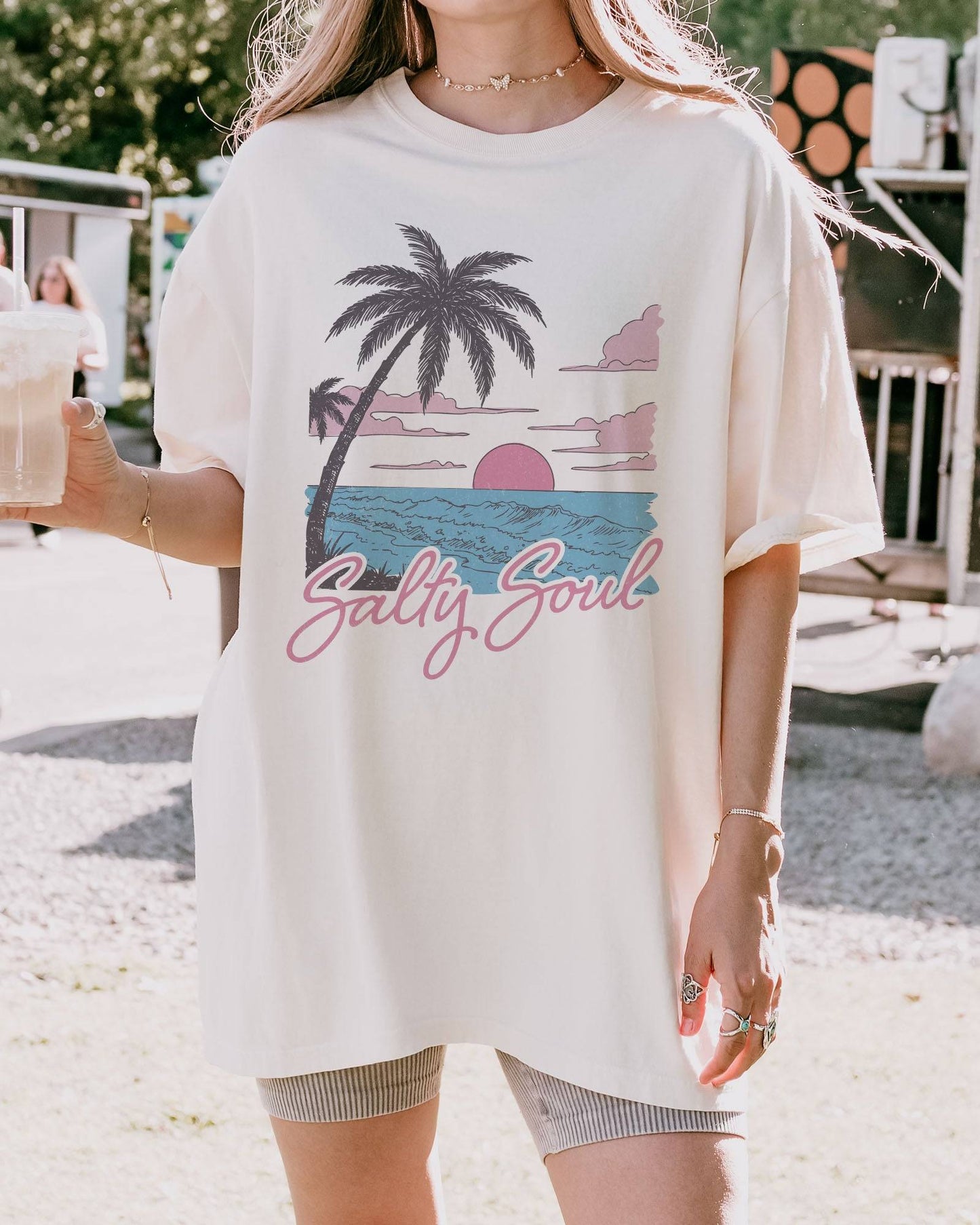 Model wearing ivory color shirt with 'Salty Soul' funny retro beach graphic design