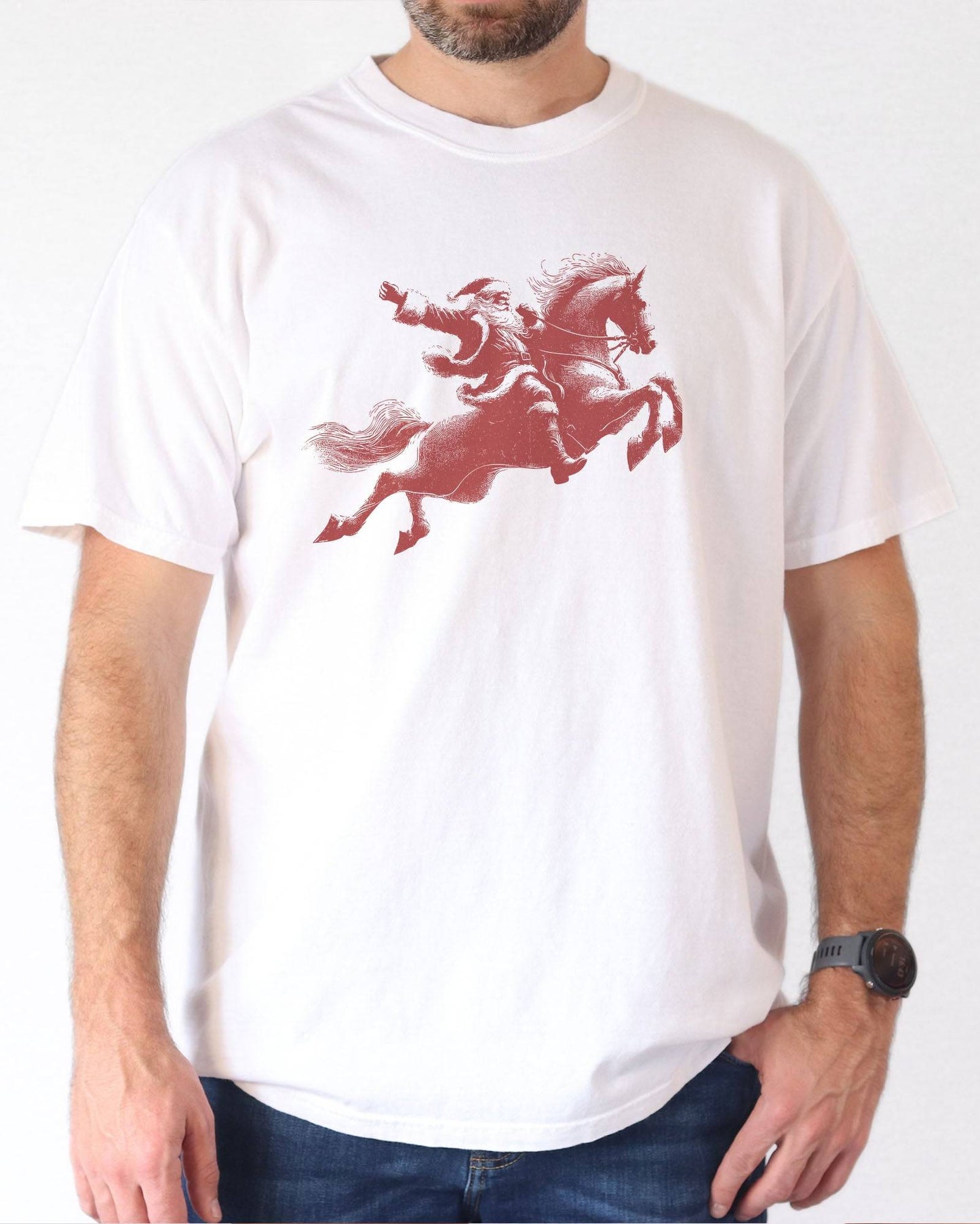 Model wearing white color shirt with 'Santa Riding A Horse' graphic design